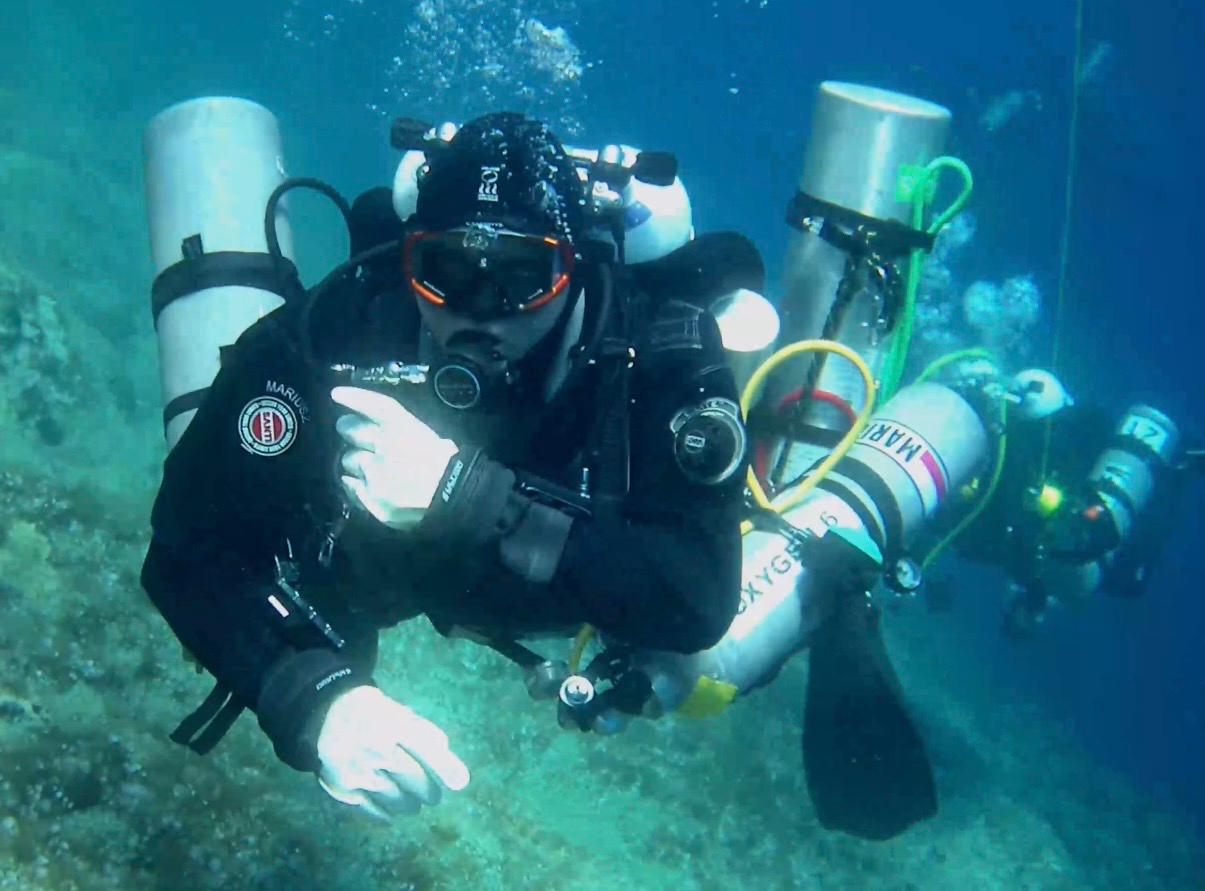 Mariusz Ciupa in a technical configuration with stage cylinders including oxygen, a second diver behind, off Vis in Croatia
